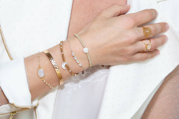 Woman neck with hand with many bracelets