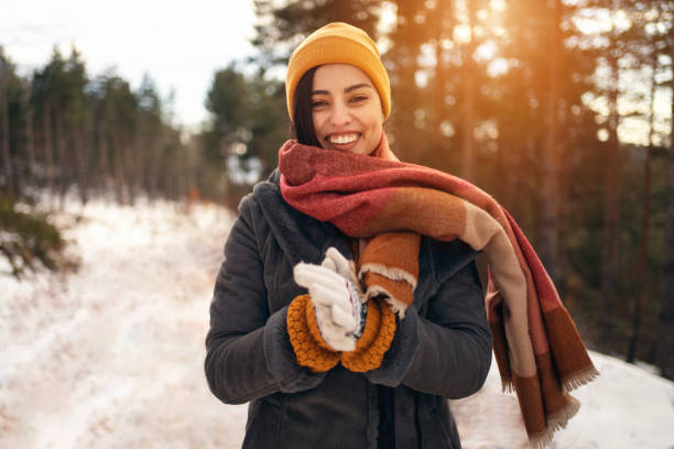 Portrait of beautiful young caucasian woman in nature during winter